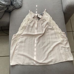 Cream lose fitting shirt. Lace on the sides